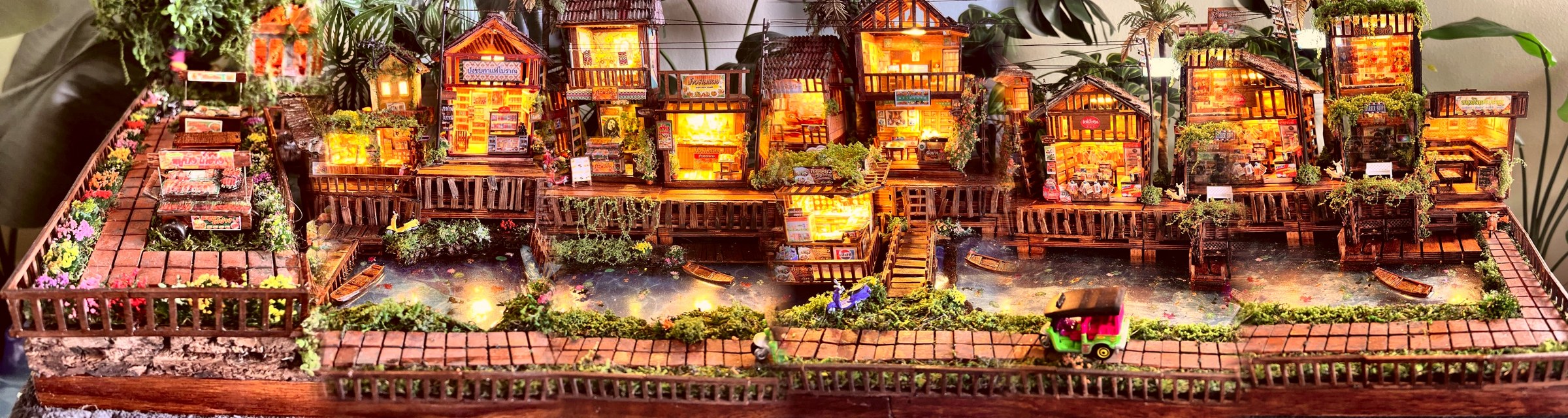 Sirena's hand-built miniature village, a panorama of the stilt houses and the river made by hand